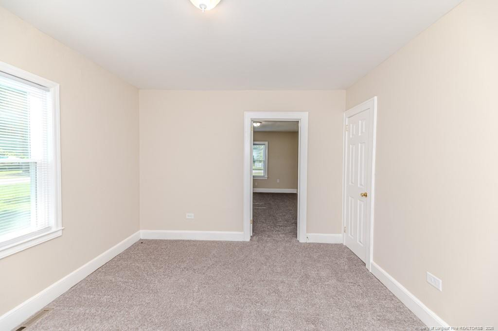 222 St Andrews Church Road Sanford, NC 27332 - Photo 22 of 24 an empty room with windows and entrance to other room
