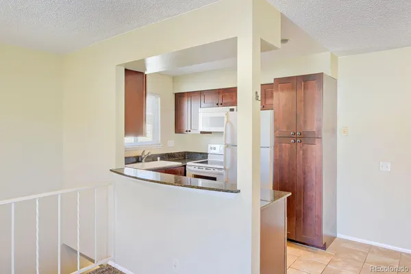 a kitchen with a refrigerator and a sink