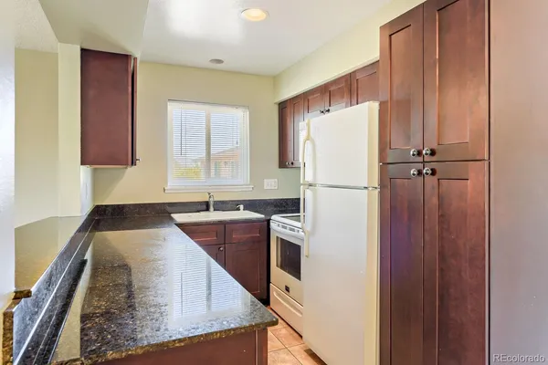 a white refrigerator freezer sitting in a kitchen
