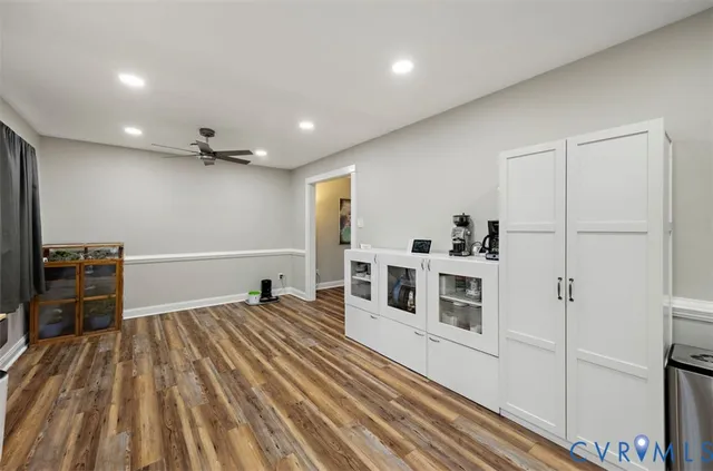 a view of a livingroom with furniture wooden floor and window