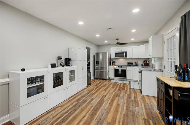 a kitchen with white cabinets stainless steel appliances and sink