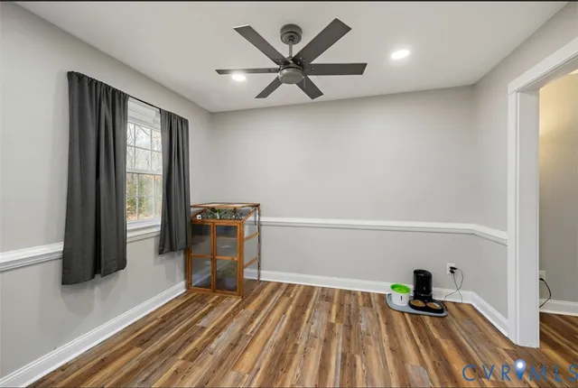 a room with wooden floor and windows