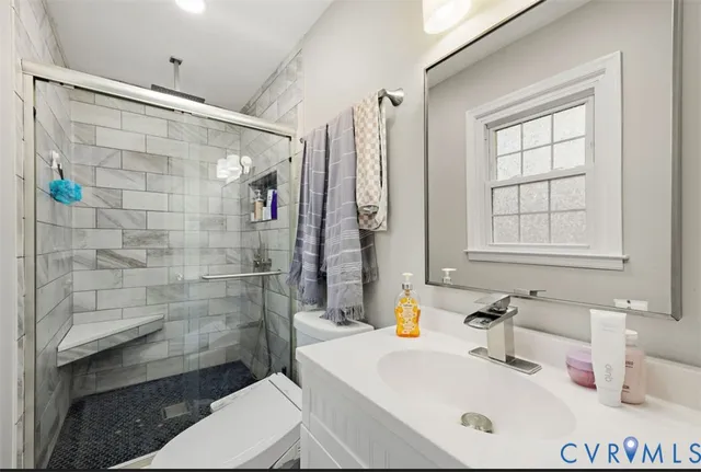 a bathroom with a sink toilet and shower