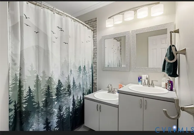 a bathroom with a sink vanity and mirror