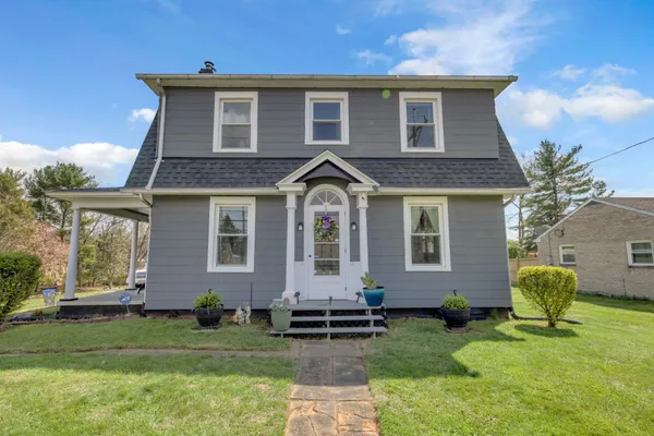a front view of a house with a yard