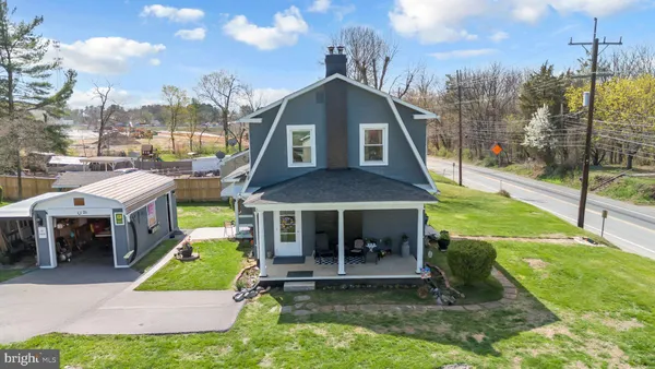 a view of a house with a yard patio and a slide