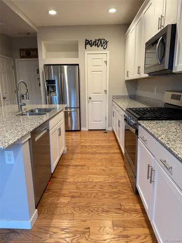 a kitchen with refrigerator and washing machine