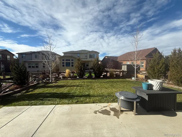 an aerial view of a pool with a table chairs