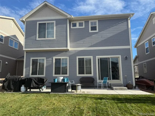 a front view of a house with a yard fire pit and outdoor seating