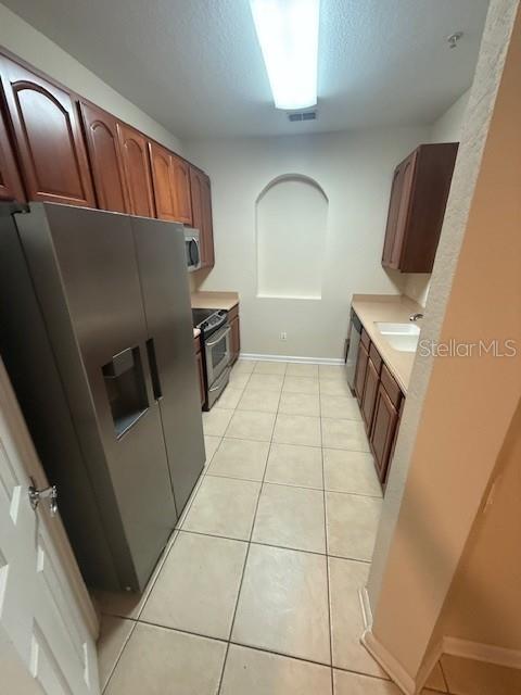 4102 Breakview Drive, Unit 207 Orlando, FL 32819 - Photo 3 of 19 a kitchen with a refrigerator