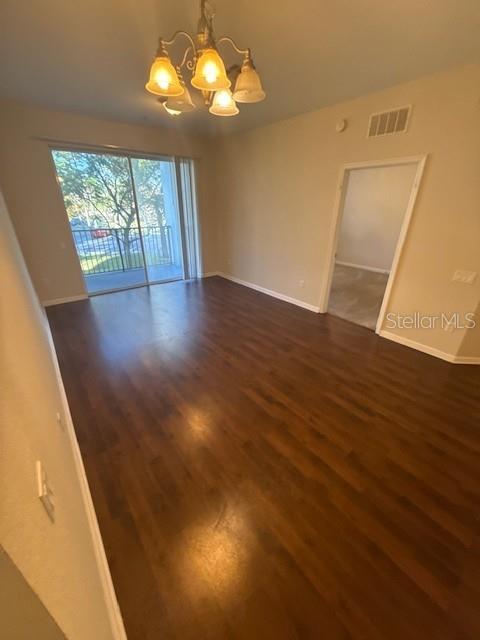 4102 Breakview Drive, Unit 207 Orlando, FL 32819 - Photo 4 of 19 wooden floor in an empty room with a window