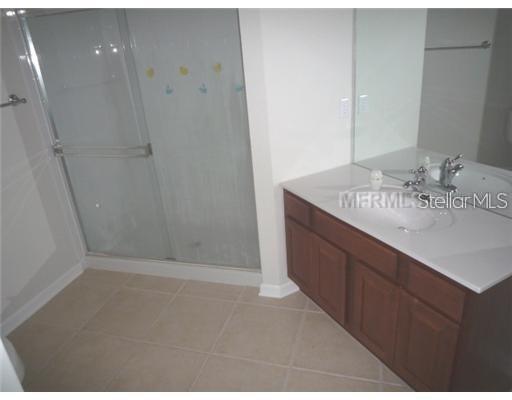 4102 Breakview Drive, Unit 207 Orlando, FL 32819 - Photo 8 of 19 a bathroom with a granite countertop sink and a mirror