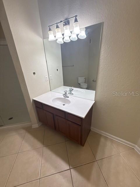 4102 Breakview Drive, Unit 207 Orlando, FL 32819 - Photo 10 of 19 a room with a table chairs and a chandelier