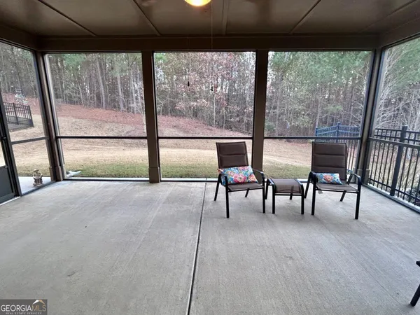 a view of livingroom with furniture and large windows