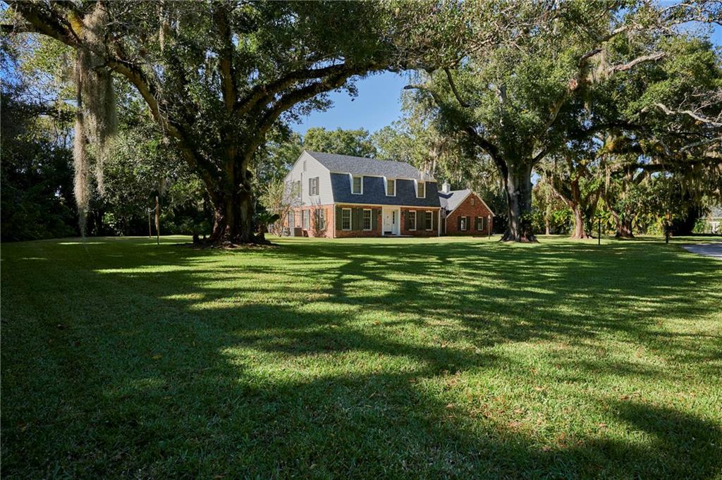 1565 48th Avenue Vero Beach, FL 32966 - Photo 2 of 34 a view of a large trees with a big yard