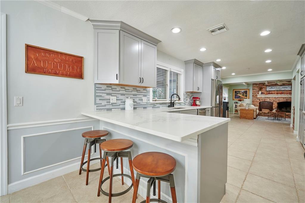 1565 48th Avenue Vero Beach, FL 32966 - Photo 16 of 34 a kitchen with stainless steel appliances granite countertop a sink and a refrigerator
