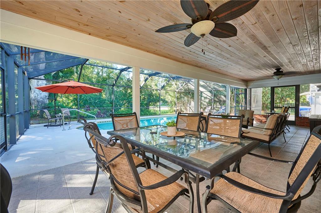 1565 48th Avenue Vero Beach, FL 32966 - Photo 19 of 34 a outdoor space with patio lots of furniture and umbrella