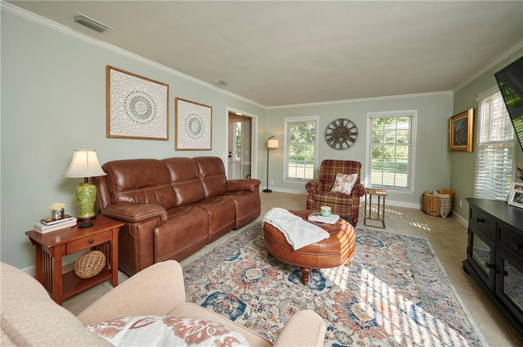 1565 48th Avenue Vero Beach, FL 32966 - Photo 21 of 34 a living room with furniture and a flat screen tv