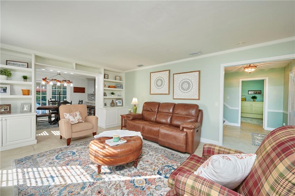 1565 48th Avenue Vero Beach, FL 32966 - Photo 22 of 34 a living room with furniture and a large window