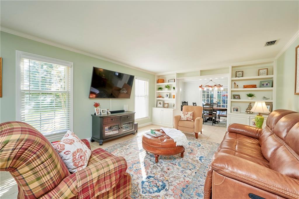 1565 48th Avenue Vero Beach, FL 32966 - Photo 23 of 34 a living room with furniture and a flat screen tv