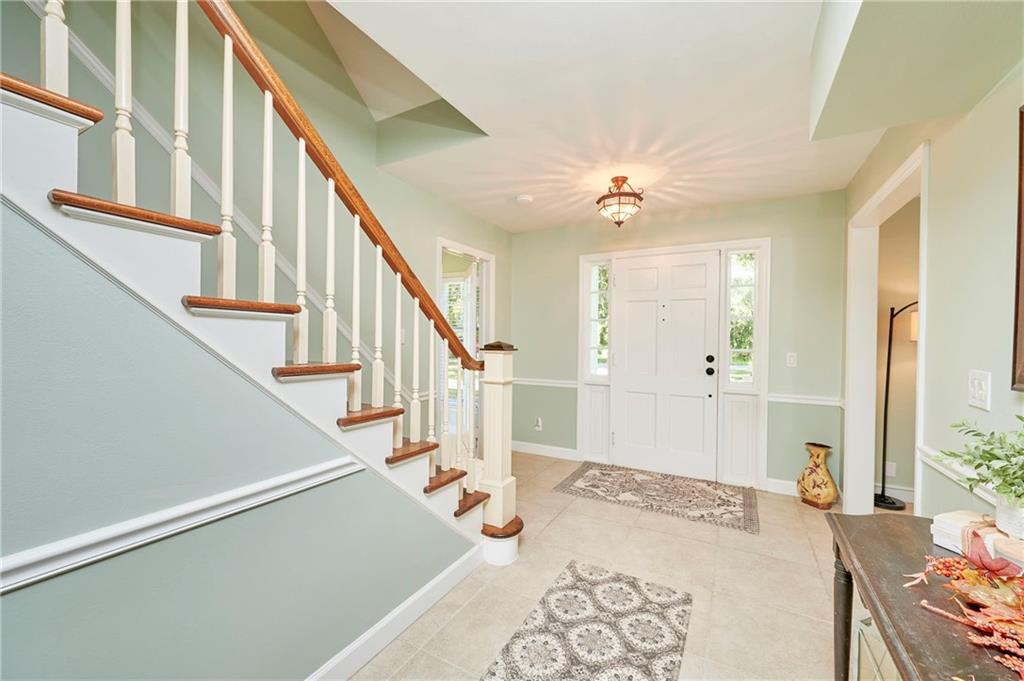 1565 48th Avenue Vero Beach, FL 32966 - Photo 25 of 34 a view of an entryway with wooden floor and a chandelier