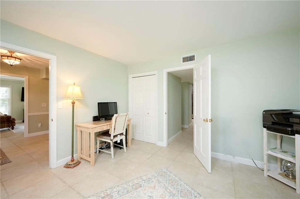 1565 48th Avenue Vero Beach, FL 32966 - Photo 27 of 34 a view of a livingroom with a flat screen tv and windows