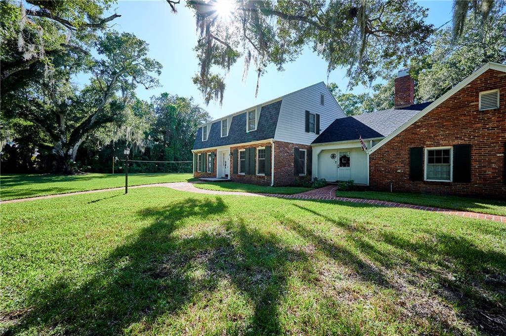 1565 48th Avenue Vero Beach, FL 32966 - Photo 4 of 34 a view of a house with yard and tree s