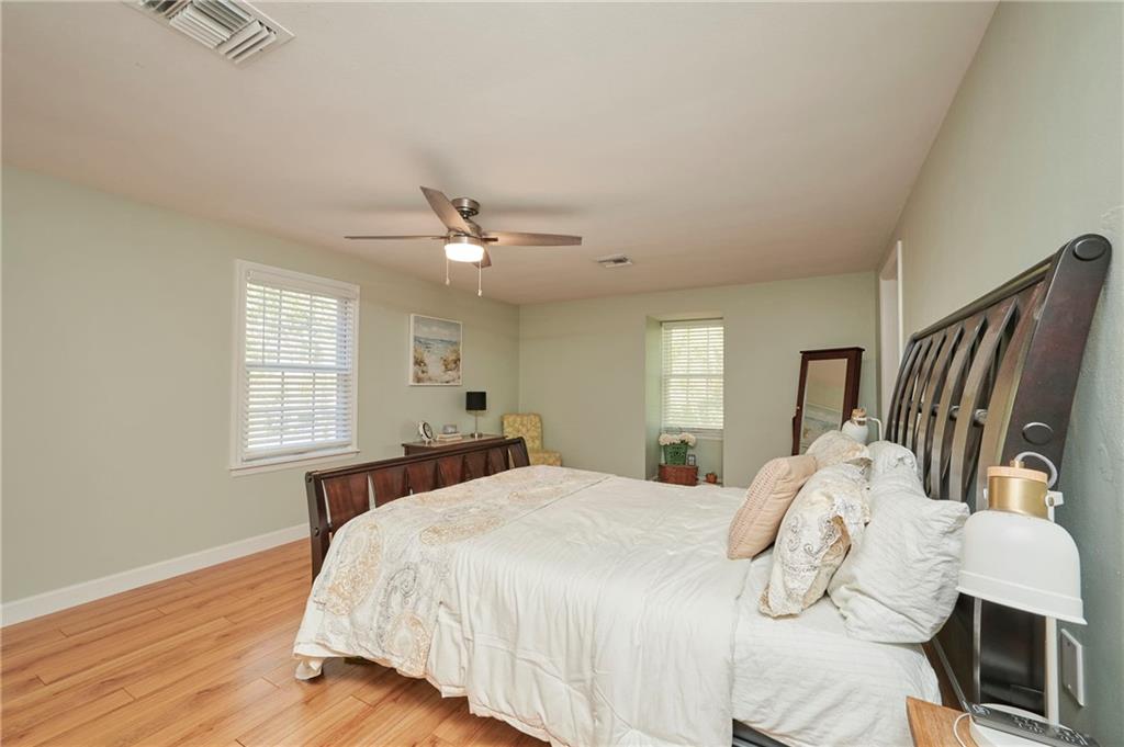 1565 48th Avenue Vero Beach, FL 32966 - Photo 31 of 34 a bedroom with a bed and wooden floor