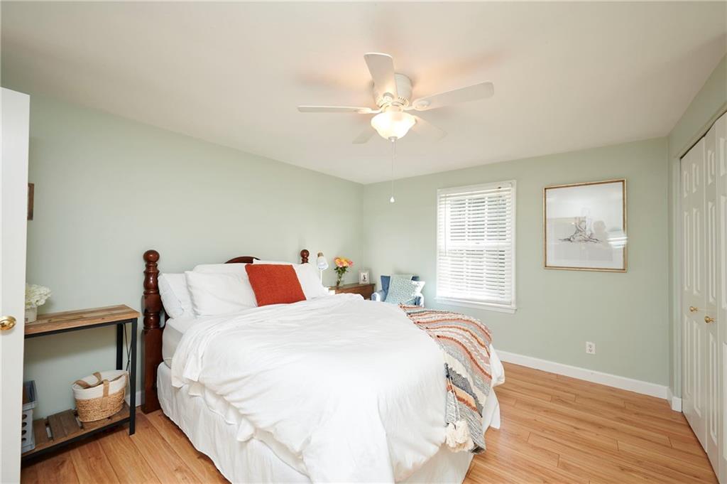 1565 48th Avenue Vero Beach, FL 32966 - Photo 32 of 34 a bedroom with a bed and a chandelier