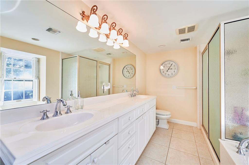 1565 48th Avenue Vero Beach, FL 32966 - Photo 33 of 34 a spacious bathroom with a sink mirror and a toilet