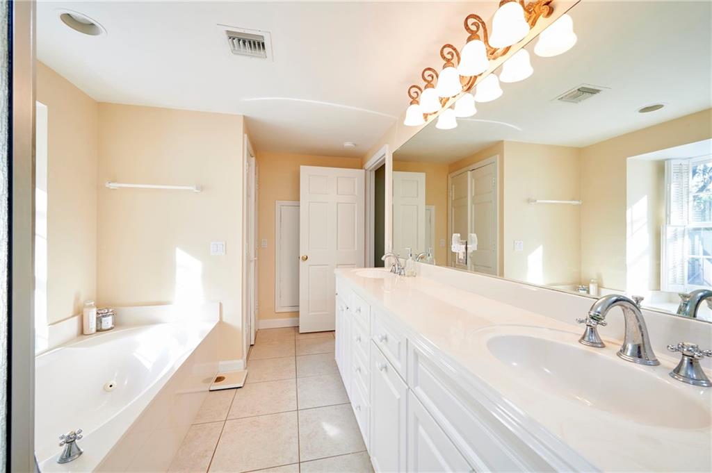 1565 48th Avenue Vero Beach, FL 32966 - Photo 34 of 34 a spacious bathroom with a large tub sink and mirror