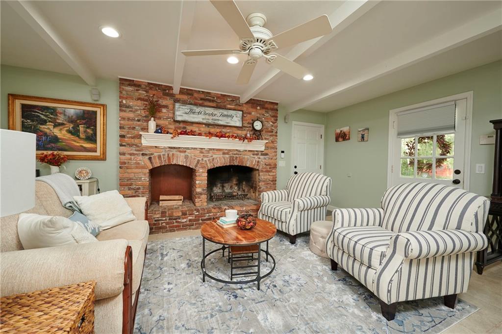 1565 48th Avenue Vero Beach, FL 32966 - Photo 8 of 34 a living room with furniture and a fireplace