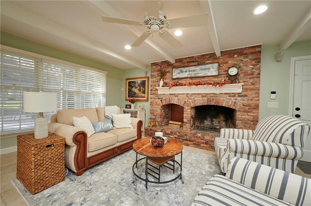 1565 48th Avenue Vero Beach, FL 32966 - Photo 9 of 34 a living room with furniture a fireplace and a large window