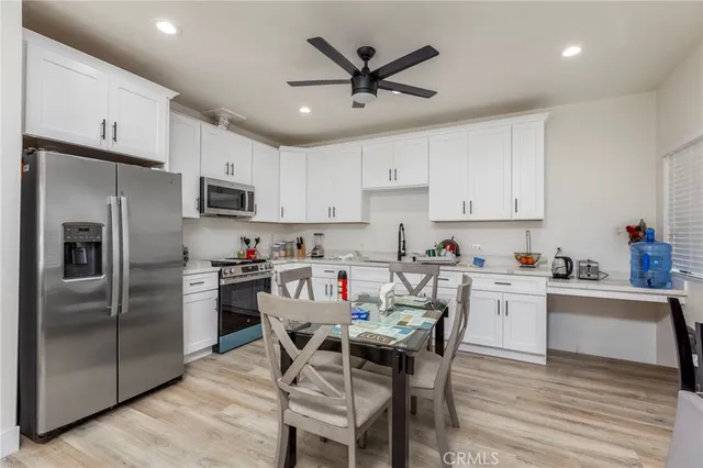 a kitchen with kitchen island a refrigerator stove microwave and cabinets