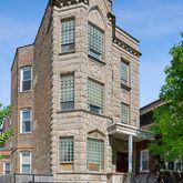 a front view of a residential apartment building with a yard