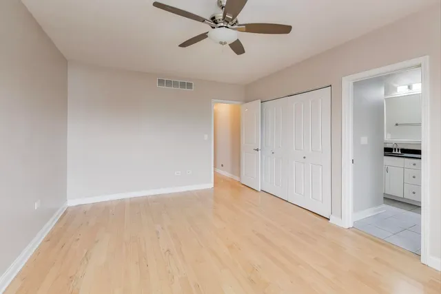 a view of an empty room and kitchen view