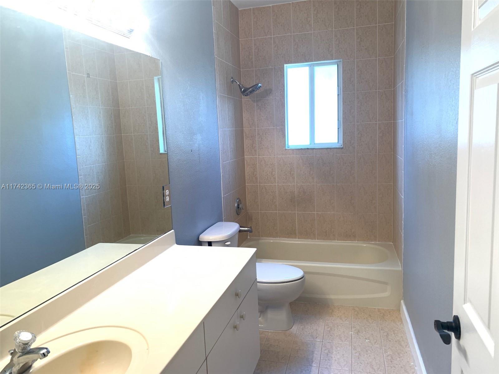 3544 Northeast 3rd Drive Homestead, FL 33033 - Photo 17 of 25 a bathroom with a sink a toilet and shower