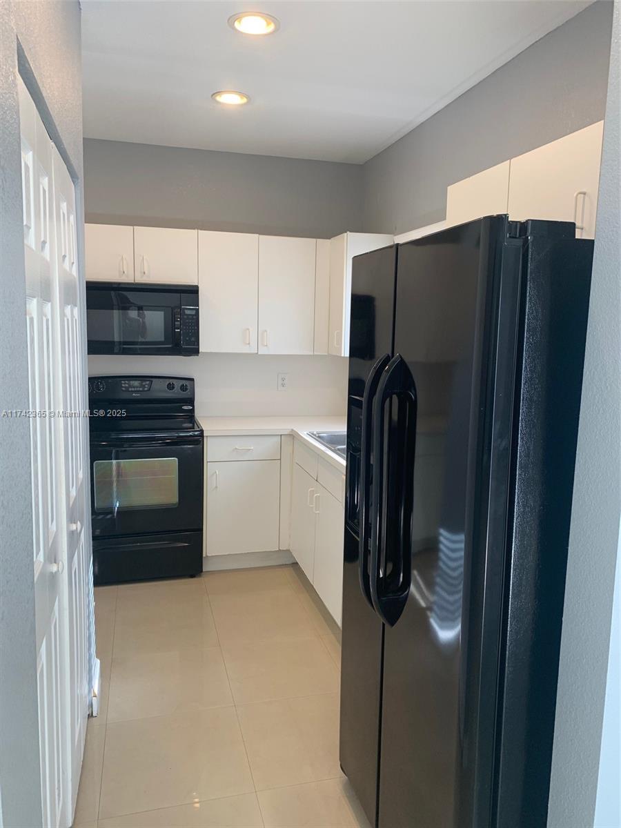 3544 Northeast 3rd Drive Homestead, FL 33033 - Photo 8 of 25 a kitchen with a refrigerator and a sink