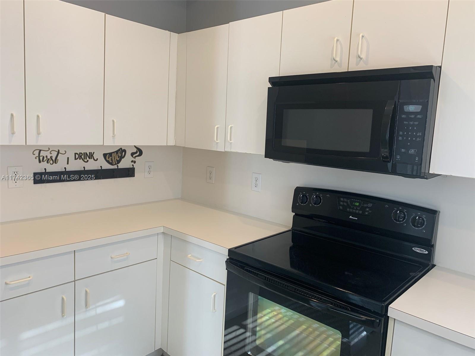 3544 Northeast 3rd Drive Homestead, FL 33033 - Photo 9 of 25 a kitchen with a stove and a microwave