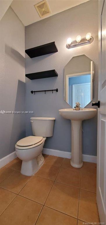 3544 Northeast 3rd Drive Homestead, FL 33033 - Photo 10 of 25 a bathroom with a toilet sink and mirror