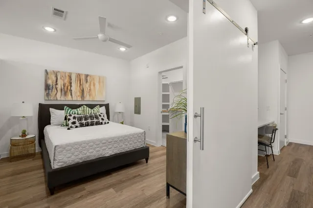 a bedroom with a bed and a table in it