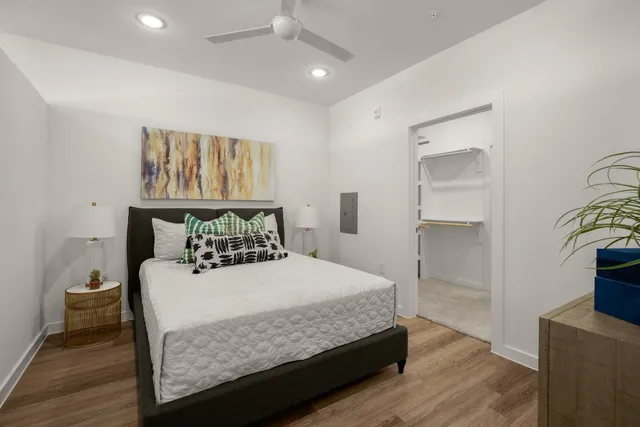 a bedroom with a bed and wooden floor