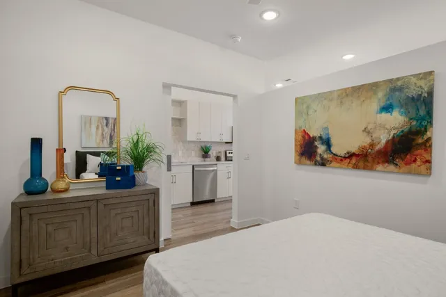 a bedroom with a bed and a potted plant