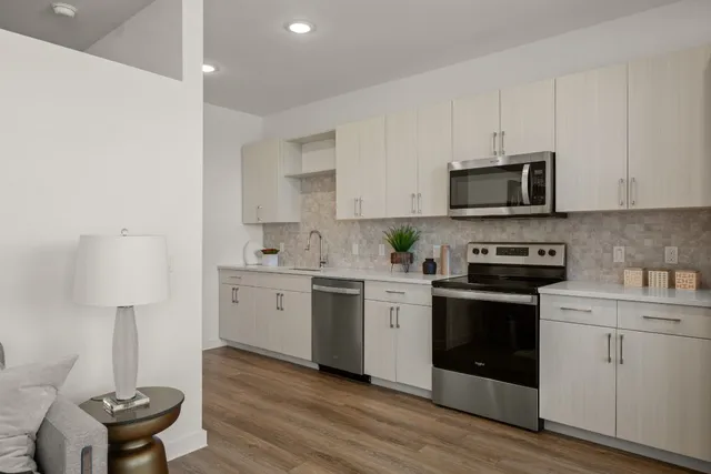 a kitchen with a sink stove and microwave