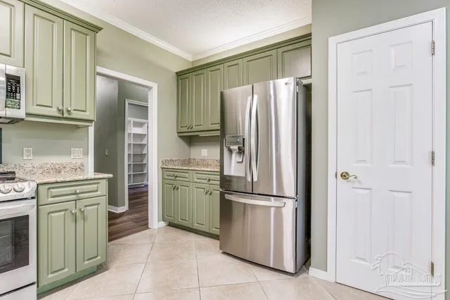 a kitchen with stainless steel appliances granite countertop a refrigerator and a stove