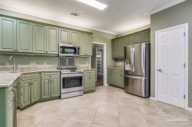 a kitchen with granite countertop a refrigerator and a sink