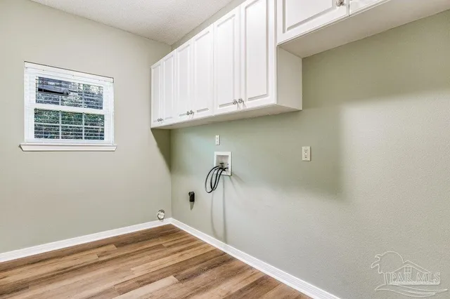 a view of a storage & utility room with a window