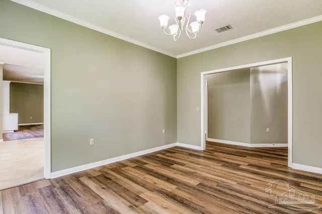 wooden floor in an empty room with a mirror