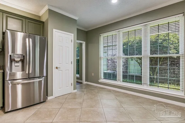 a view of kitchen with windows and refrigerator