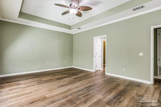 a view of an empty room and wooden floor
